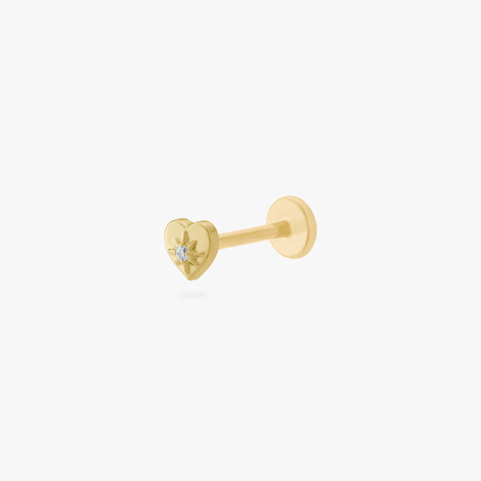 This is an image of a gold-toned titanium flatback stud in the shape of a heart with a twinkle shaped star within it, and a crystal CZ within that.
