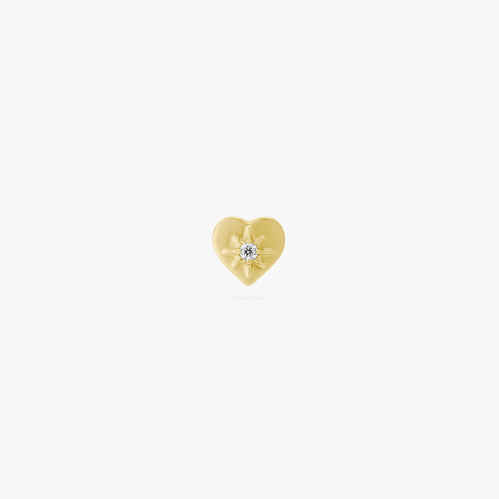 This image is an anodized yellow titanium flatback stud that is heart-shaped with a central twinkle star with a crystal CZ on a white background.