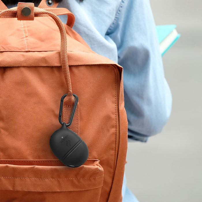 A person in a light blue shirt with turquoise books and an orange backpack has a black, oval Catalyst Case US Waterproof Case + Carabiner for Google Pixel Buds (2020/A-Series 2021) clipped to the strap. The background is neutral and blurred.