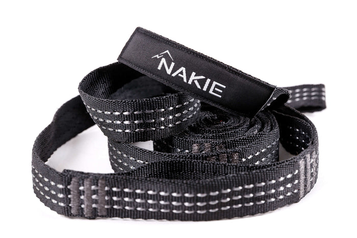 Black hammock straps with reflective stitching and branded label, coiled view
