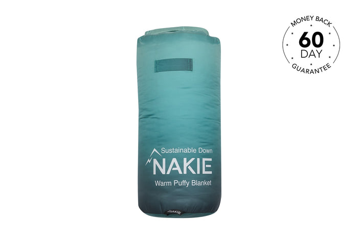 Horizon green puffy blanket rolled up with carry handle and NAKIE branding visible on front