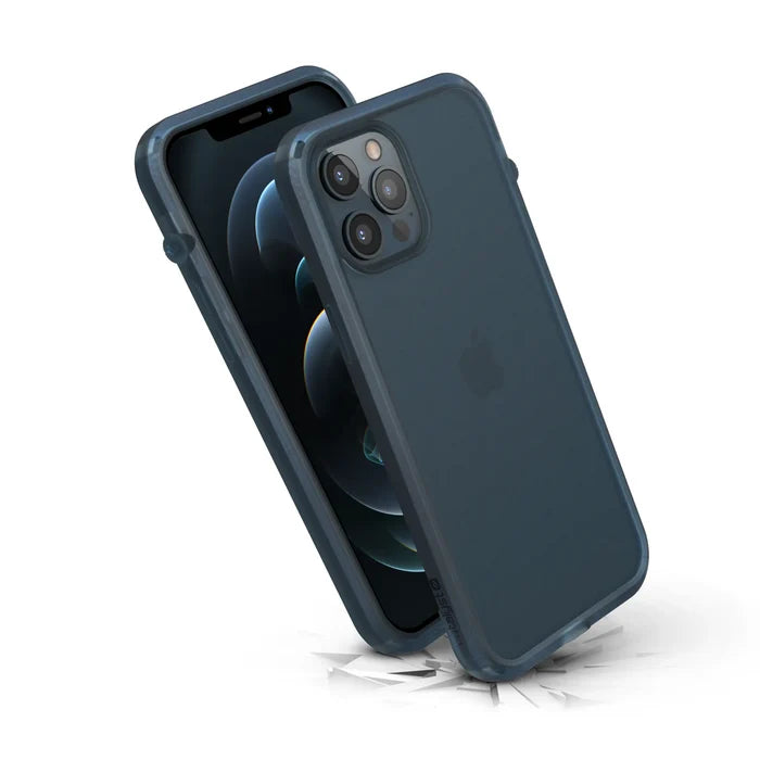 Two iPhone 12 Pro Max phones in dark blue Influence Cases by Catalyst Case US. One stands upright, screen forward; the other angles to display rear cameras and Apple logo, both on a cracked white surface showcasing their rugged, drop-proof protection.