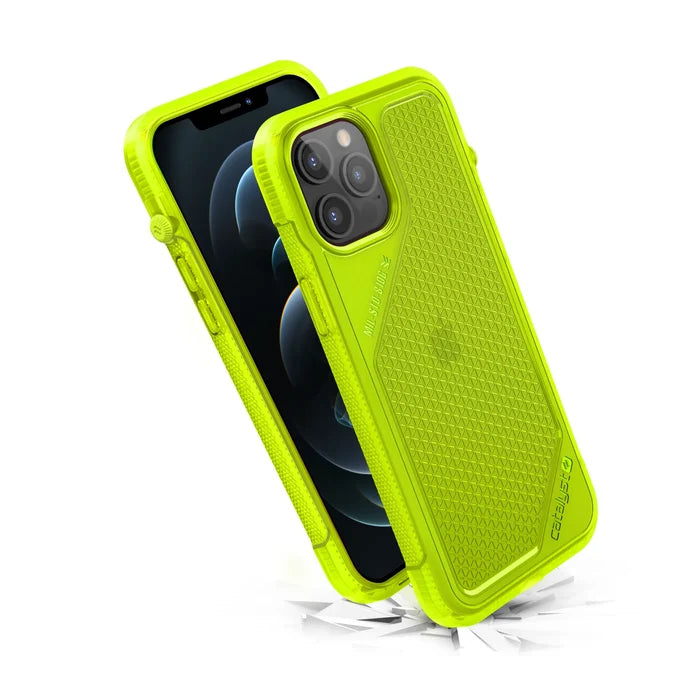 The Catalyst Case US Vibe Case for iPhone 12 Pro Max is shown in neon yellow with a rugged, hexagonal-textured design and reinforced corners, displaying both front and back views. Cracks beneath suggest drop protection; the phone screen appears black.