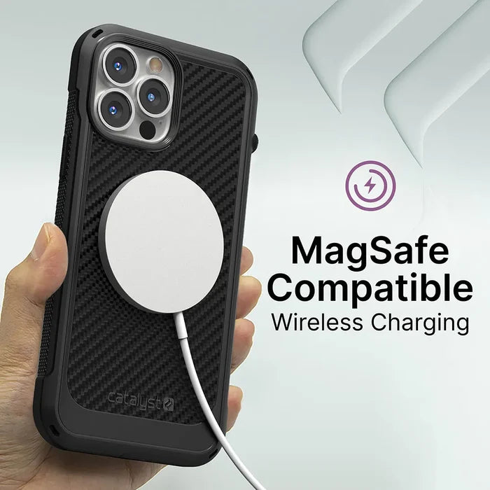A hand holds an iPhone 13 Pro in a black, textured Catalyst Vibe Case US. A white MagSafe wireless charger is attached. Text reads "MagSafe Compatible Wireless Charging" on a light background with subtle geometric shapes.