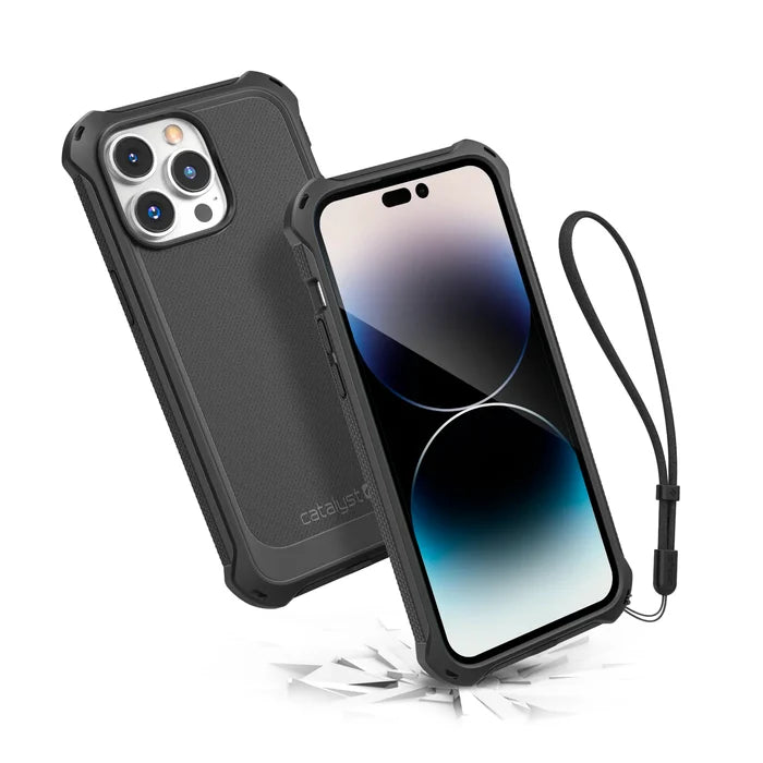 Two iPhone 14 Pro Max smartphones in Catalyst Case US Crux Cases (Stealth Black, Magsafe Compatible) are shownÃƒÂ¢Ã¢â€šÂ¬Ã¢â‚¬Âone displays three rear cameras; the other with a black wrist strap bounces on a cracked surface, proving its drop-proof protection.