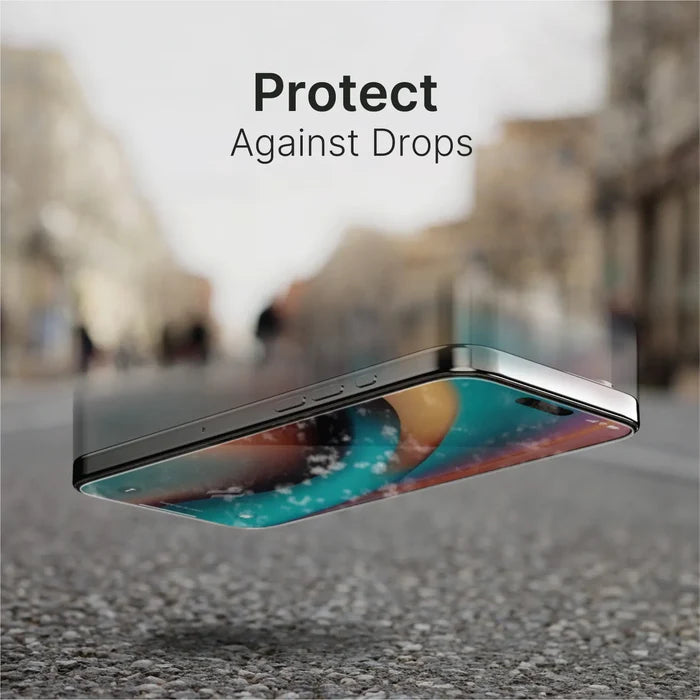 A smartphone with a Catalyst Case US Tempered Glass Screen Protector falls screen-first onto a hard street. The blurred urban background features trees and buildings. Bold text above the phone reads, "Protect Against Drops.