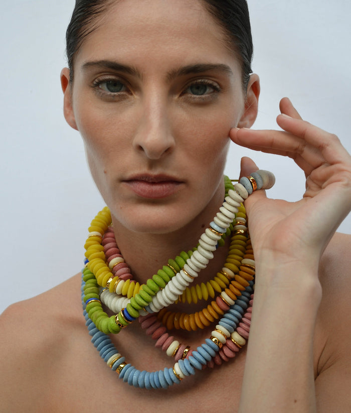 Model wears stack of colorful Laguna Necklaces