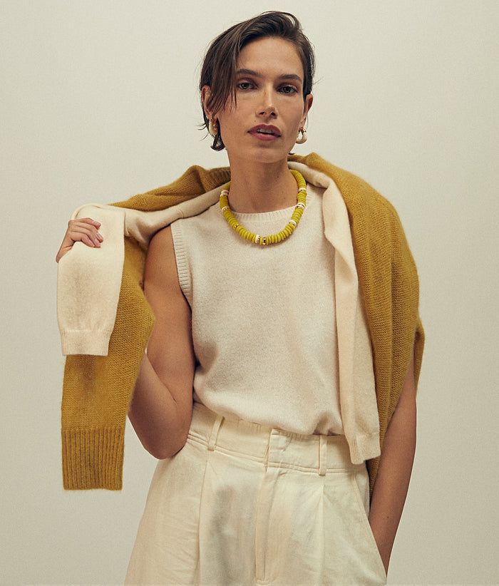 Model wears cream outfit with Laguna Necklace in Yellow and Organic Hoops in Alabaster