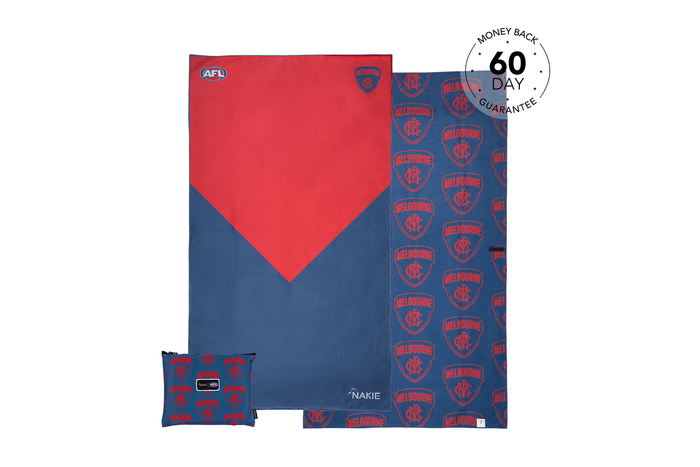 Red and navy AFL Melbourne Demons beach towel with geometric design and matching small cushion pillow, sand-free fabric