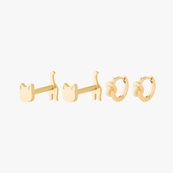 Gold earring set featuring a pair of reversible cat flatbacks and a pair of knot huggies
