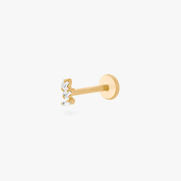 This is an image of a gold-toned titanium flatback stud with 3 micro baguette cut stones placed in a cluster.