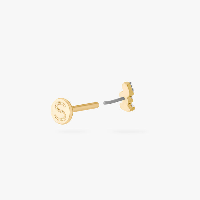 This is an image of a gold-toned titanium flatback stud with 3 micro baguette cut stones placed in a cluster. This image shows the earring facing away from the camera, separated from the flatback post.