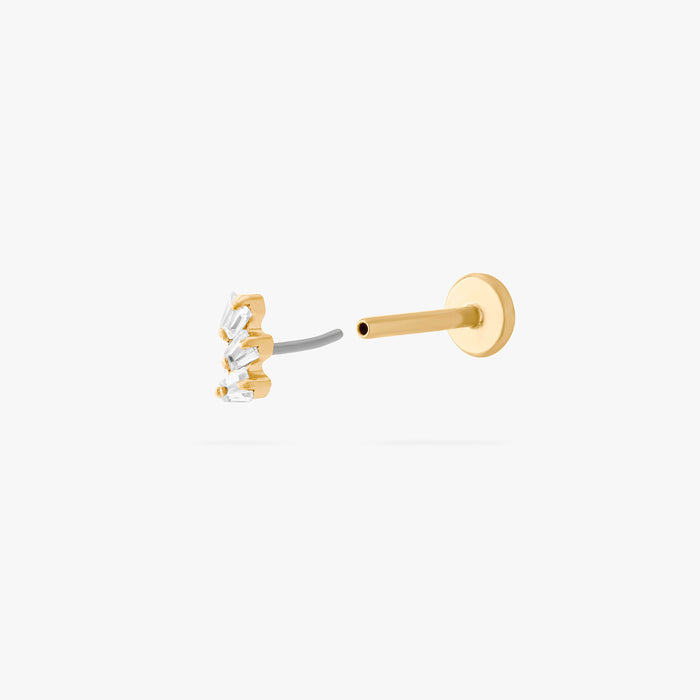 This is an image of a gold-toned titanium flatback stud with 3 micro baguette cut stones placed in a cluster. This image shows the earring facing the camera, separated from the flatback post.