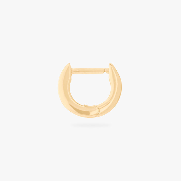 This is an image of a 14K gold plated huggie earring with 4 baguette cut, bezel set crystal CZs along the edge.