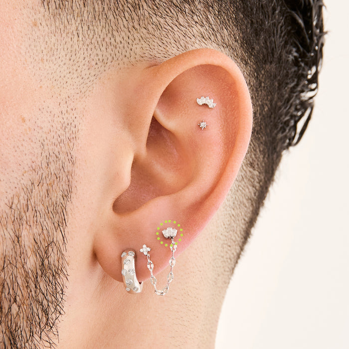 This is an image of a silver-toned flatback stud that is micro baguette shaped CZ's in a crown shape on ear. [hover] color:null|silver/clear