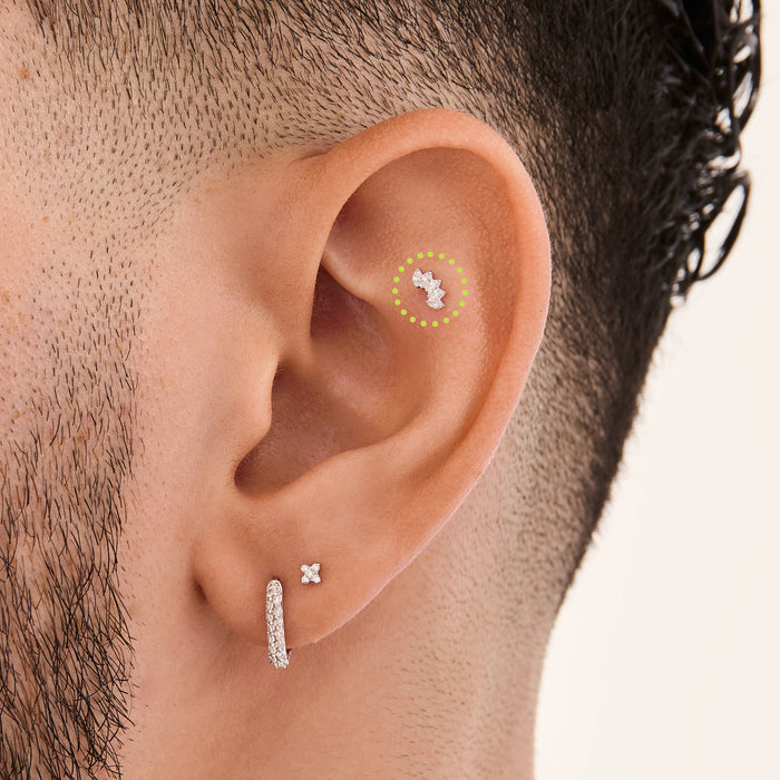 This is an image of a micro-sized silver toned stud with CZ's in a crown marquise shape on ear. [hover] color:null|silver/clear