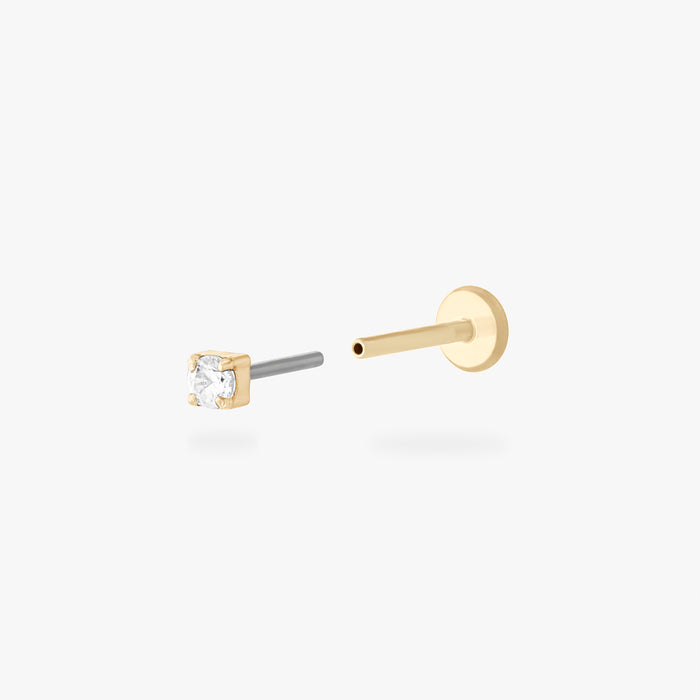 Gold stud flatback earring with a micro clear cz gemstone on a white background