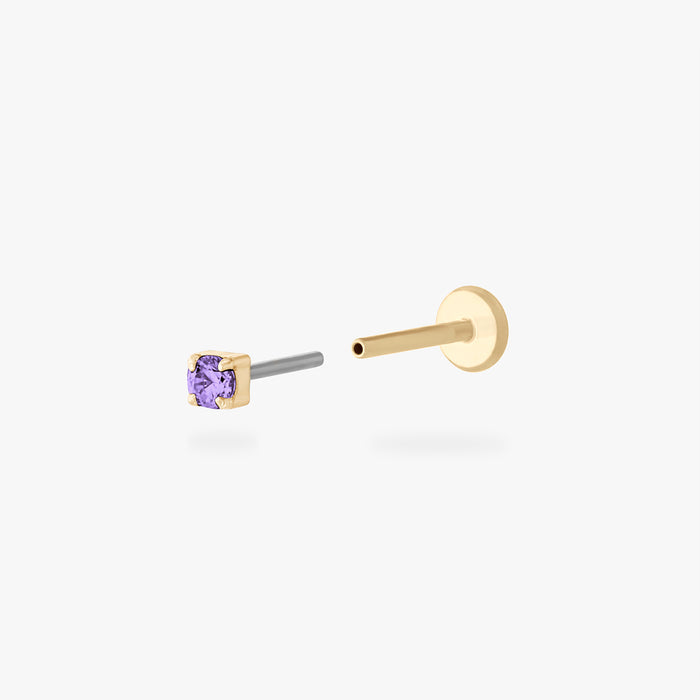 Gold stud flatback earring with a micro purple cz gemstone on a white background
