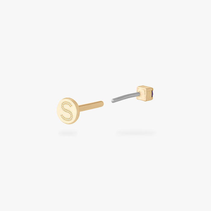 Gold flatback stud earring with engraved letter S and small purple micro CZ stones shown from side angle
