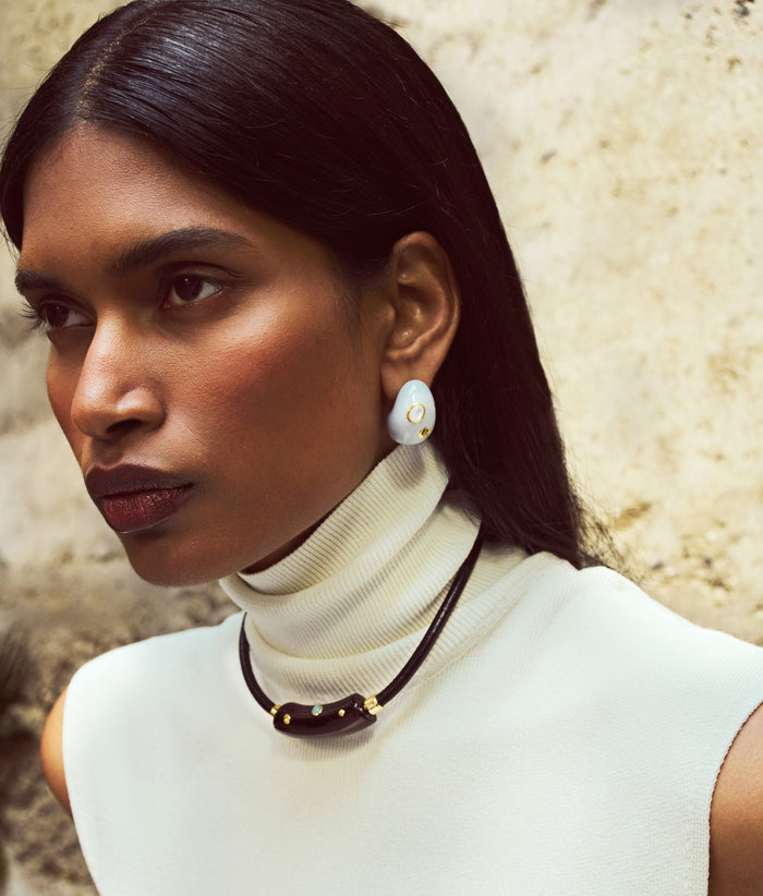 Model in cream knit top wears Cabrera Collar and Mini Arp Earrings in Studded Mist