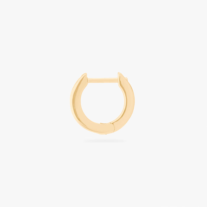 This is an image of a 14K gold plated huggie earring with 6 baguette cut, bezel set crystal CZs along the edge.