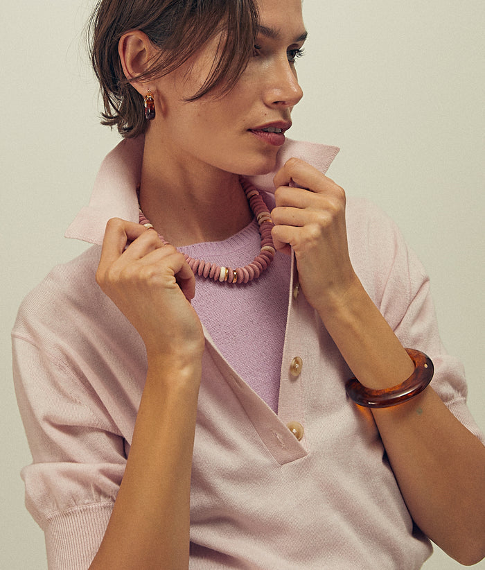 Model in pink layers wears Mini Organic Hoops and Ridge Cuff in Tortoise with Laguna Necklace in Rose Pink