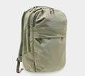 Olive-green canvas daypack backpack with two zip compartments, front zip pocket and padded shoulder straps