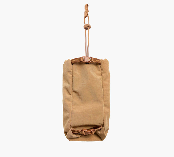 Front view of MODE Bottle Sleeve in Mojave showcasing cinch cord and buckle hanging loop on white background