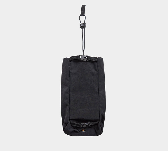 Front view of MODE Bottle Sleeve in black showing hanging strap with plastic clip and roll-top buckle on light gray background