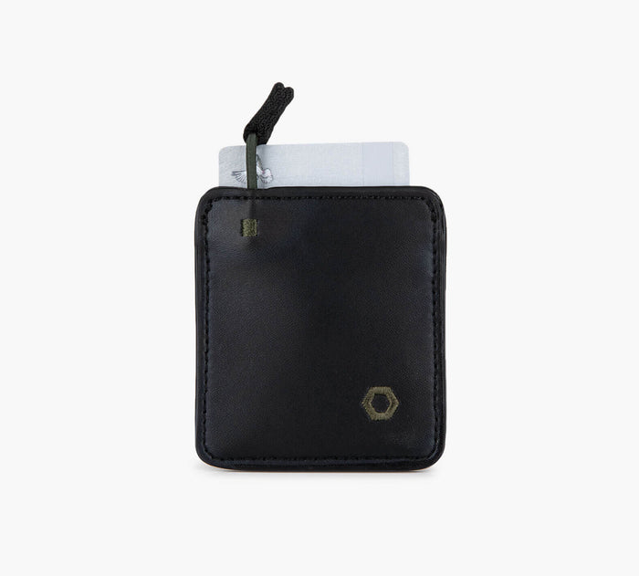 Compact black leather card sleeve with pull tab and two cards partially visible; small gold hexagon logo