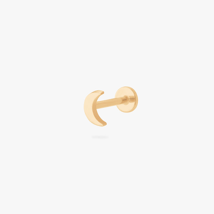 This is an image of a gold moon shaped flatback top with a gold labret with a circle disc with the "S" logo engraved in it. color:null|gold/clear|gold