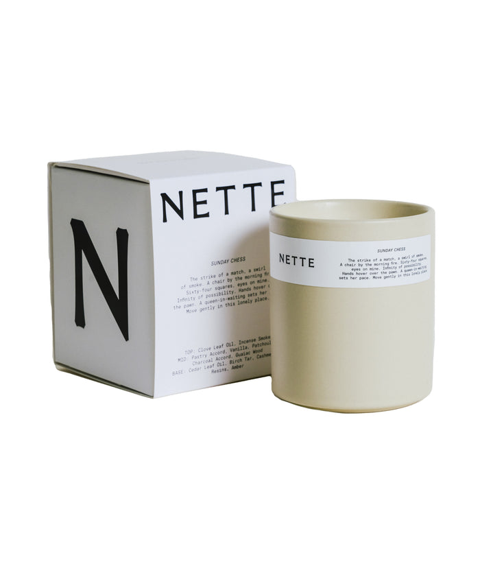 Ceramic candle vessel with graphic cardboard box.
