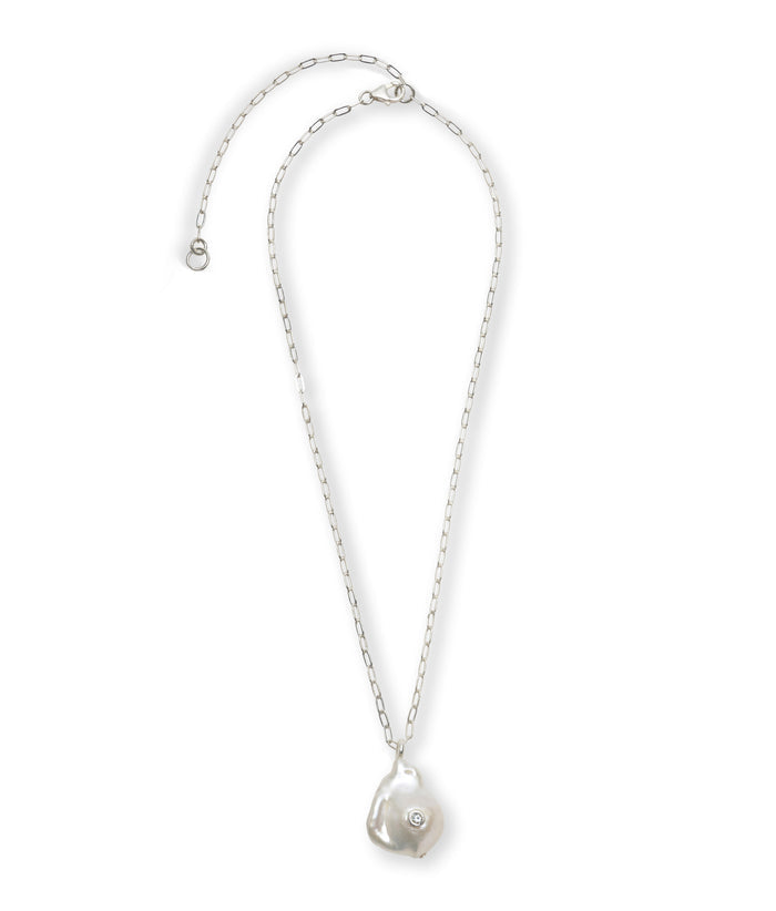 Oasis Necklace in Silver. Delicate silver chain with pearl pendant inlaid with sky blue topaz.
