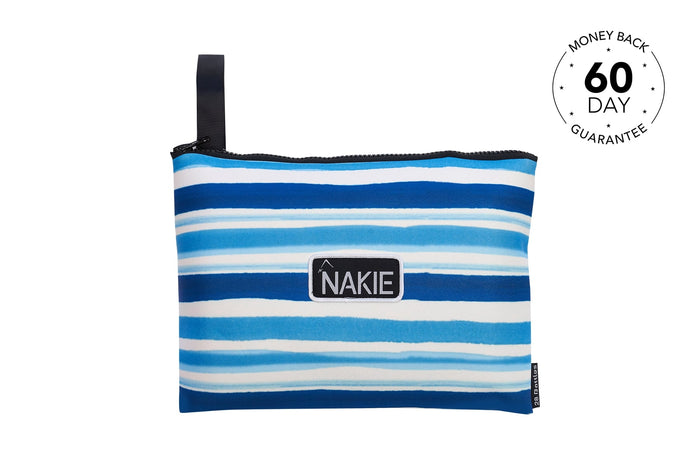 Blue and white striped recycled sand-free beach towel with black carry handle and Nakie logo patch, front view.