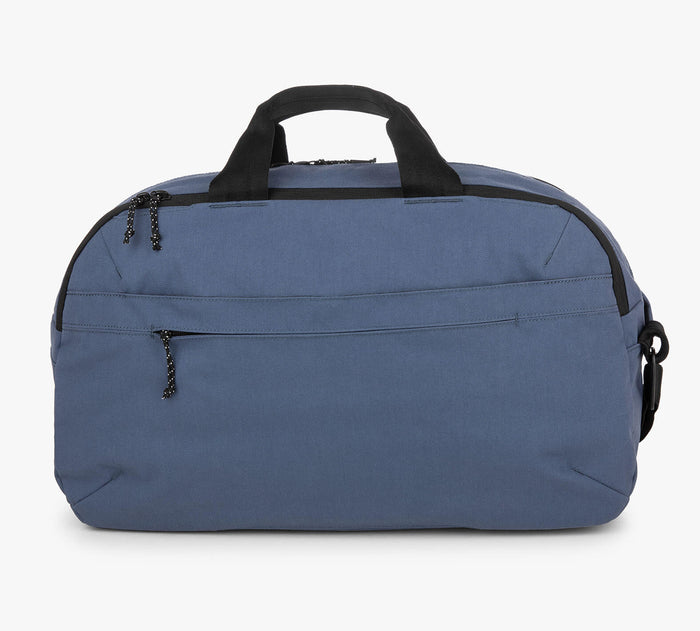Small blue zip-top duffel bag with front and top zip pockets and black handles.