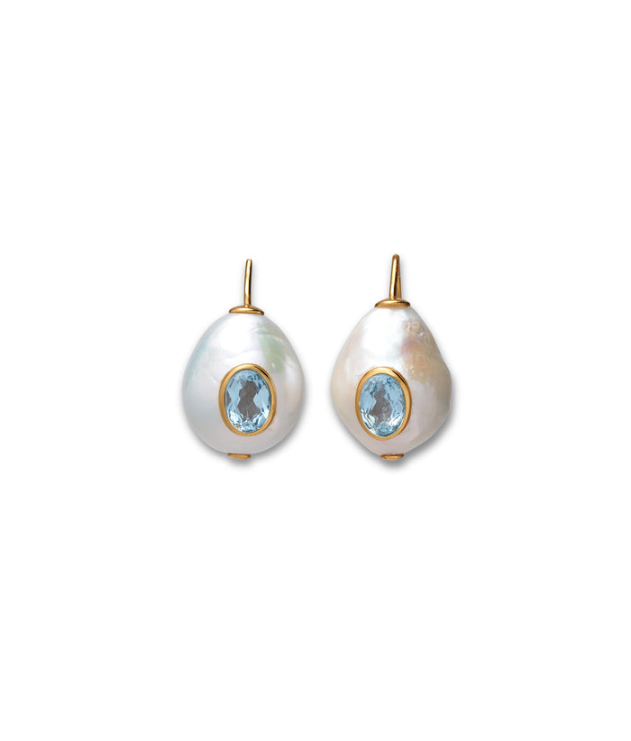 Gold ear wires with freshwater pearl drops inlaid with faceted sky blue topaz stones.