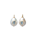 Gold ear wires with freshwater pearl drops inlaid with faceted sky blue topaz stones.