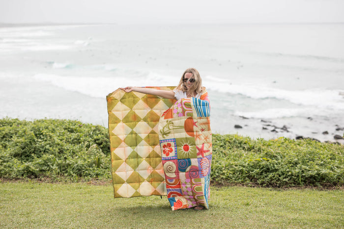 Retro Shores sustainable down puffy blanket with geometric diamond and colorful patchwork pattern
