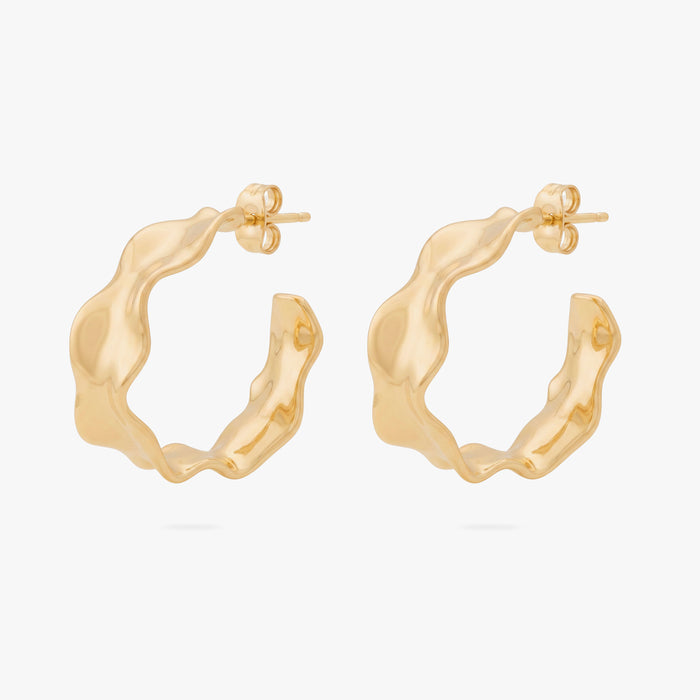 This image shows the front view of a pair of 14k gold plated hoops with an organic shapes around the hoop