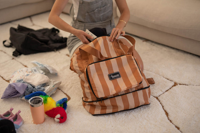 Sandy Trails tan and cream striped recycled tote bag with black trim, held open to show interior packing capacity
