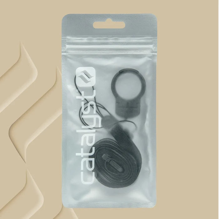 A transparent, resealable package labeled "Catalyst Case US" displays the Shoulder Strap & Ring Stand Bundle—featuring a black ring, strap, and clip—arranged neatly against a beige background with abstract 3D shapes on the left.