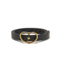 Skinny Georgia Belt In Black. Thin black leather belt with gold-plated brass kidney-shaped buckle.