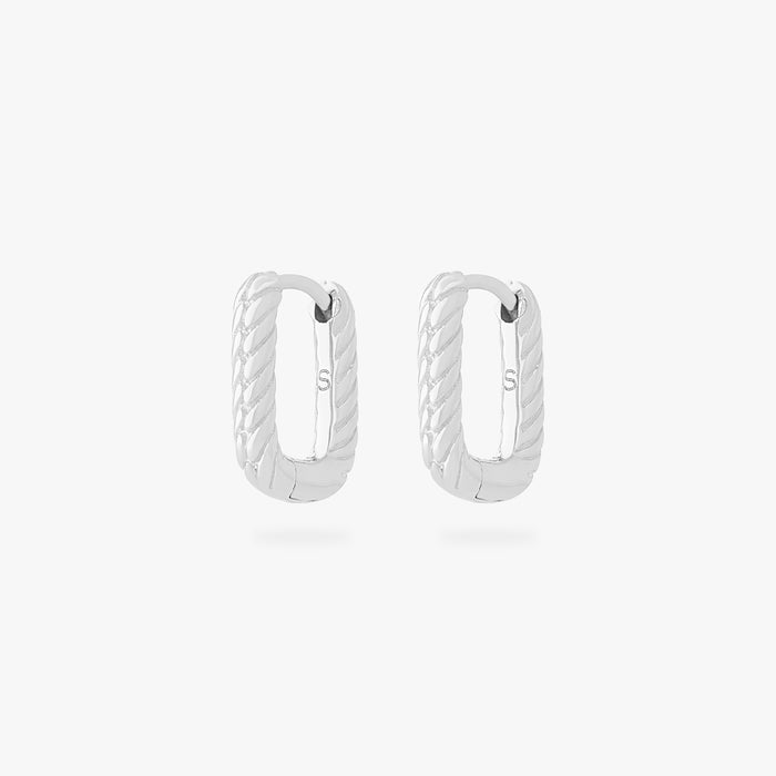 This is an image of a pair of silver-toned, square shaped huggies that have twists throughout them. [pair] color:null|silver