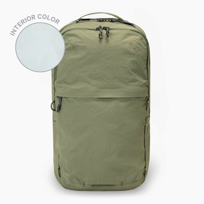 Pakt. travel backpack, cypress green front view with zippered pocket and interior color swatch labeled INTERIOR COLOR