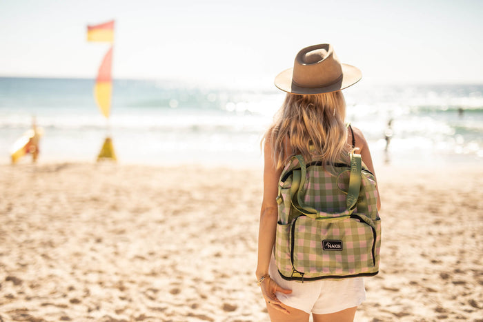 Strawberry Fields recycled tote bag in pink and green gingham, worn on shoulder at beach