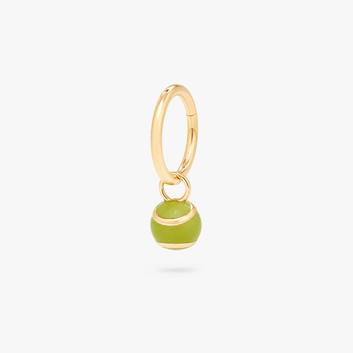 This image shows a green tennis ball charm on a gold clicker