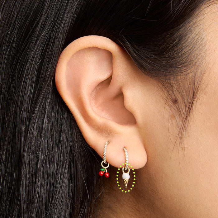 This is an image of a gold earring charm in the shape of an ice cream cone with white and tan enameling on ear. [hover] color:null|gold