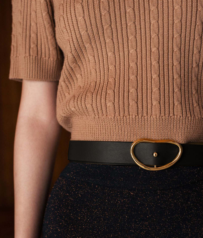 Close-up on model's waist, wearing Wide Georgia Belt in Black with black skirt and camel knit sweater