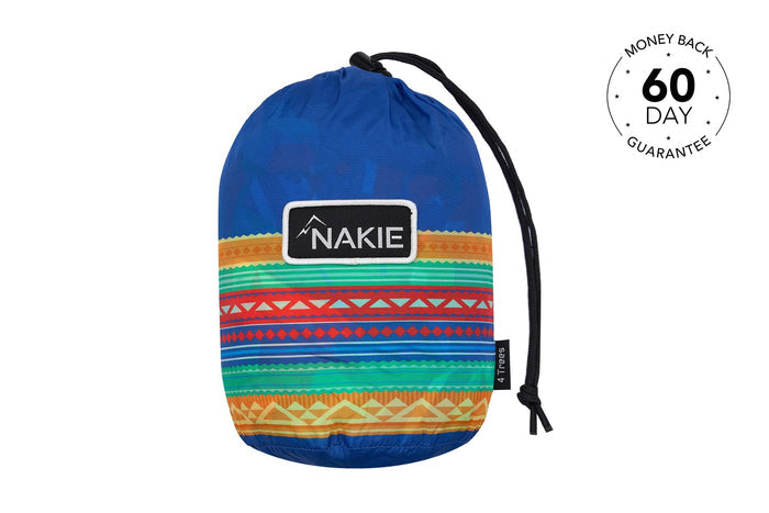 Blue recycled hammock with multicolored geometric striped pattern, black carrying straps, and Nakie logo patch.