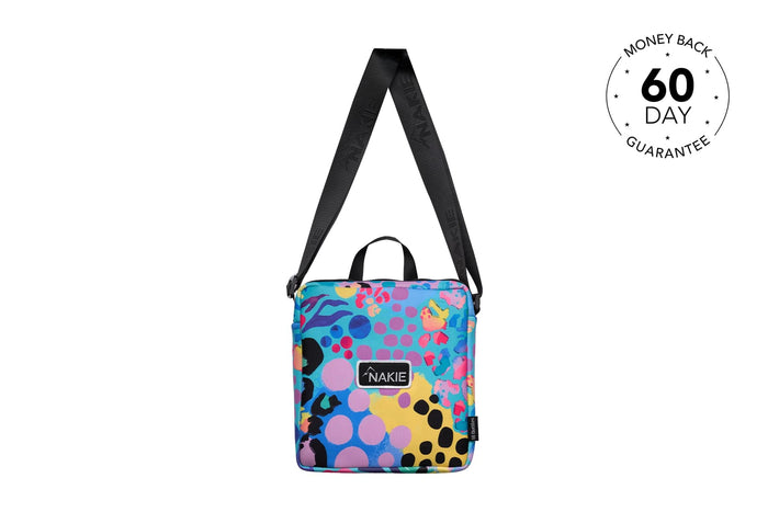 Colorful beach towel bag with multi-colored polka dots and abstract shapes, black handles and shoulder strap